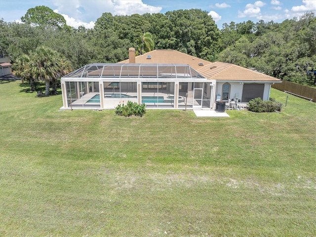 8827 Scout Lake Ct, New Port Richey, FL 34654 - back of property featuring an outdoor pool, a patio, glass enclosure, and a wooded view