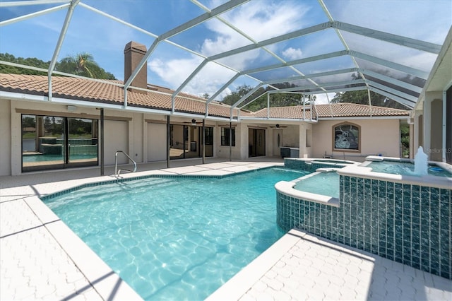 8827 Scout Lake Ct, New Port Richey, FL 34654 - view of pool with ceiling fan, a pool with connected hot tub, a patio, and a lanai