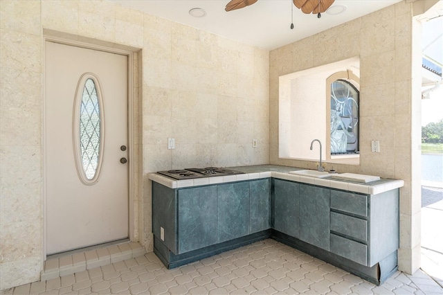8827 Scout Lake Ct, New Port Richey, FL 34654 - kitchen featuring a sink, tile counters, a ceiling fan, light tile patterned floors, and gray cabinetry