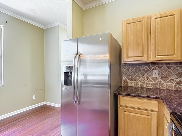 8576 Sandy Beach St, Tampa, FL 33634 - kitchen with stainless steel fridge, wood finished floors, backsplash, crown molding, and baseboards