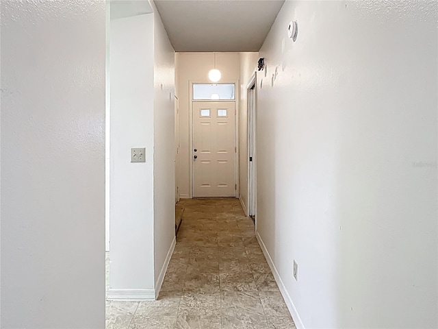1556 Lynda Ln, Dunedin, FL 34698 - hallway featuring baseboards and stone finish floors