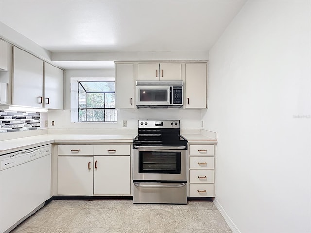 1556 Lynda Ln, Dunedin, FL 34698 - kitchen with stainless steel appliances, light countertops, backsplash, and baseboards