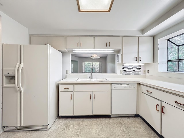 1556 Lynda Ln, Dunedin, FL 34698 - kitchen with white appliances, a sink, light countertops, and white cabinetry
