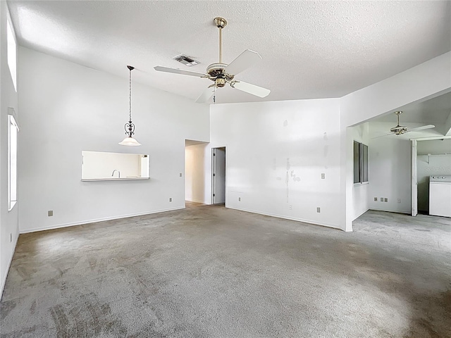 1556 Lynda Ln, Dunedin, FL 34698 - unfurnished living room featuring a ceiling fan, carpet, a textured ceiling, washer / dryer, and baseboards