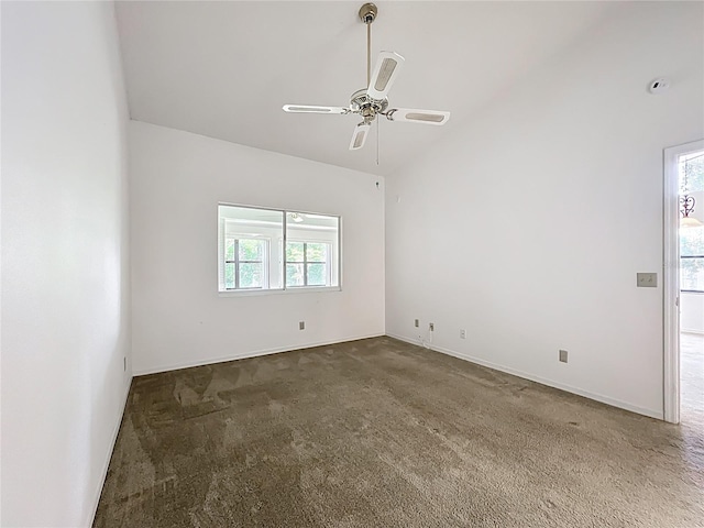 1556 Lynda Ln, Dunedin, FL 34698 - spare room with dark colored carpet, ceiling fan, vaulted ceiling, and baseboards