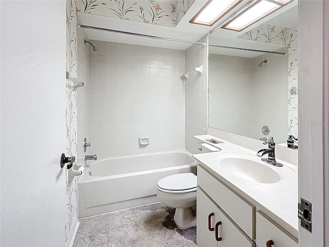 1556 Lynda Ln, Dunedin, FL 34698 - bathroom featuring toilet, vanity,  shower combination, and stone finish flooring