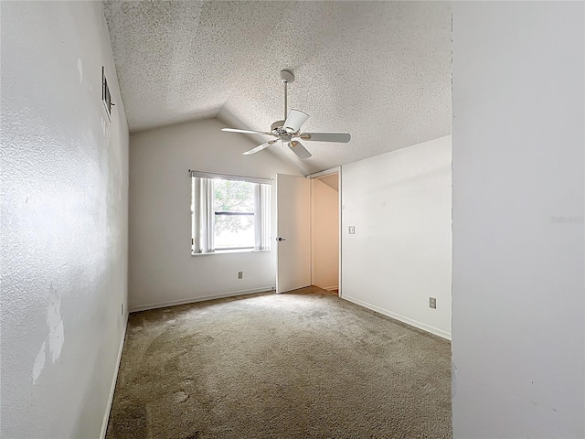 1556 Lynda Ln, Dunedin, FL 34698 - unfurnished bedroom with lofted ceiling, carpet, a textured ceiling, ceiling fan, and baseboards