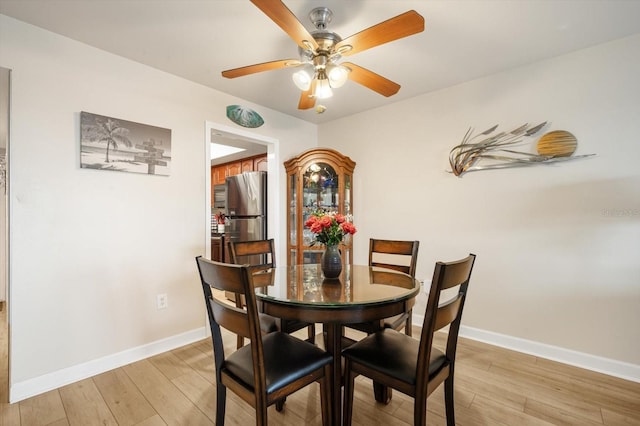 5130 Brittany Dr S Unit 604, Saint Petersburg, FL 33715 - dining area with light wood-style flooring, ceiling fan, and baseboards