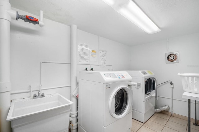 5130 Brittany Dr S Unit 604, Saint Petersburg, FL 33715 - communal laundry room with washer and clothes dryer and light tile patterned floors