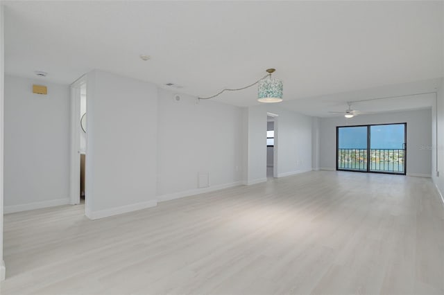 7050 Sunset Dr S Unit 1401, South Pasadena, FL 33707 - unfurnished room featuring light wood-style flooring, a ceiling fan, and baseboards