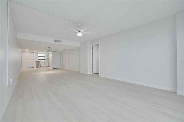 7050 Sunset Dr S Unit 1401, South Pasadena, FL 33707 - unfurnished living room with ceiling fan, baseboards, and light wood-style floors