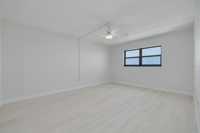 7050 Sunset Dr S Unit 1401, South Pasadena, FL 33707 - unfurnished room with light wood-style floors, ceiling fan, baseboards, and a textured ceiling