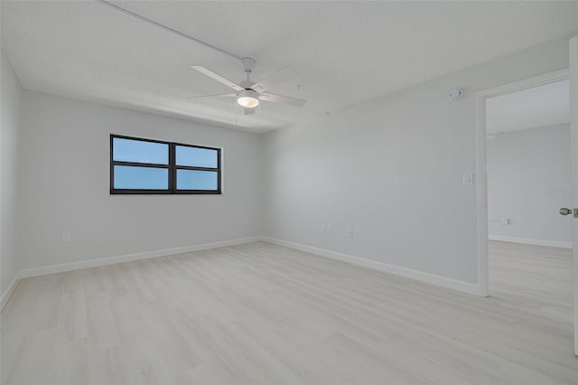 7050 Sunset Dr S Unit 1401, South Pasadena, FL 33707 - empty room with ceiling fan, light wood finished floors, and baseboards