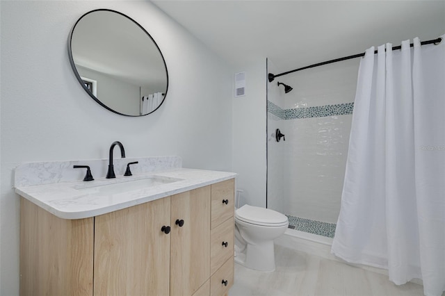 7050 Sunset Dr S Unit 1401, South Pasadena, FL 33707 - bathroom with vanity, toilet, and a tile shower