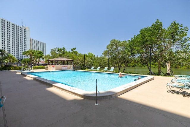 7050 Sunset Dr S Unit 1401, South Pasadena, FL 33707 - community pool featuring a gazebo, a patio, and view of wooded area