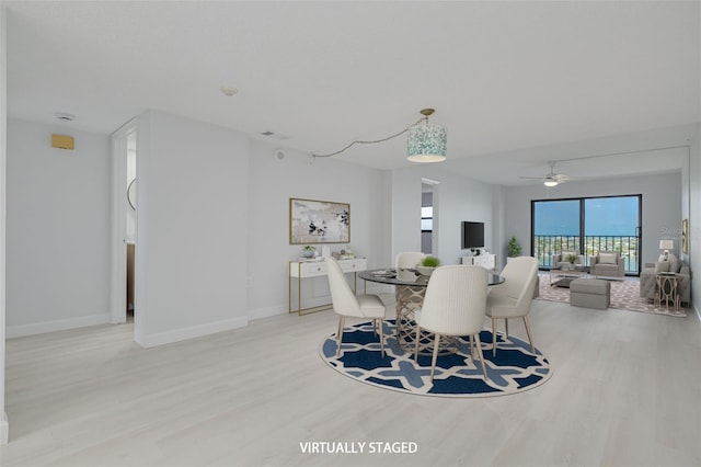 7050 Sunset Dr S Unit 1401, South Pasadena, FL 33707 - dining room with wood finished floors, baseboards, and a ceiling fan
