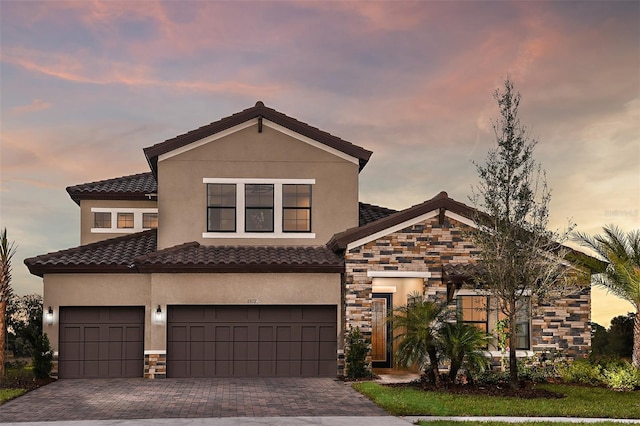 13726 Heartwood Way, Parrish, FL 34219 - view of front facade featuring stone siding, stucco siding, and decorative driveway