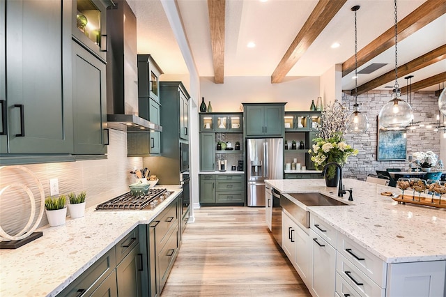13726 Heartwood Way, Parrish, FL 34219 - kitchen featuring stainless steel appliances, a sink, tasteful backsplash, wall chimney range hood, and light wood-style flooring