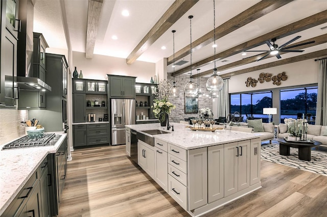 13726 Heartwood Way, Parrish, FL 34219 - kitchen featuring stainless steel appliances, a sink, open floor plan, tasteful backsplash, and wall chimney exhaust hood