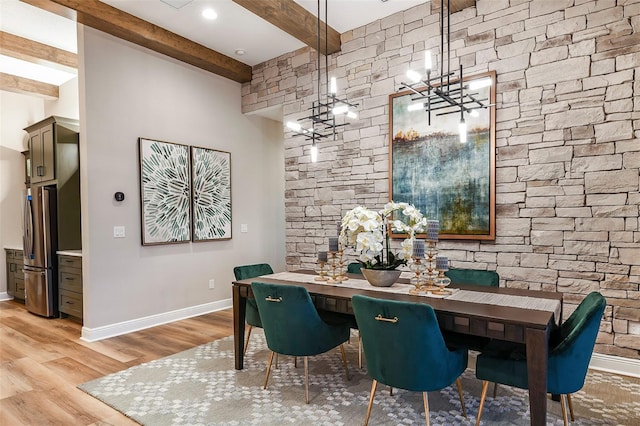 13726 Heartwood Way, Parrish, FL 34219 - dining space with beam ceiling, a chandelier, light wood finished floors, and baseboards