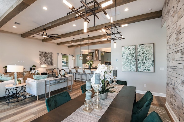 13726 Heartwood Way, Parrish, FL 34219 - dining room with beamed ceiling, wood finished floors, a chandelier, baseboards, and a ceiling fan