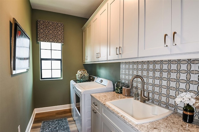 13726 Heartwood Way, Parrish, FL 34219 - laundry area with cabinet space, washer and clothes dryer, baseboards, and wood finished floors
