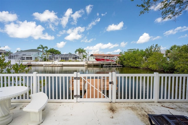 4315 Flexer Dr, Hernando Beach, FL 34607 - view of patio / terrace with a water view, a gate, fence, and a dock