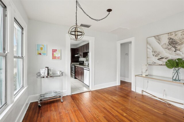 2015 3rd St S, Saint Petersburg, FL 33705 - dining room with light wood finished floors, healthy amount of natural light, and baseboards