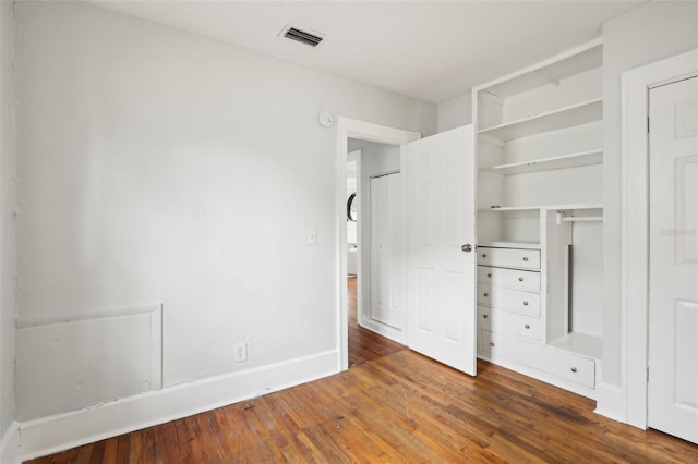 2015 3rd St S, Saint Petersburg, FL 33705 - unfurnished bedroom with wood finished floors and baseboards