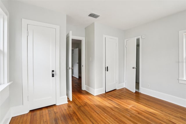 2015 3rd St S, Saint Petersburg, FL 33705 - unfurnished bedroom with hardwood / wood-style flooring and baseboards