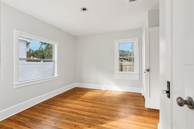 2015 3rd St S, Saint Petersburg, FL 33705 - spare room featuring plenty of natural light, wood finished floors, and baseboards