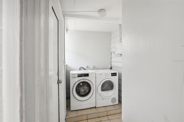 2015 3rd St S, Saint Petersburg, FL 33705 - washroom featuring washing machine and clothes dryer and light tile patterned floors