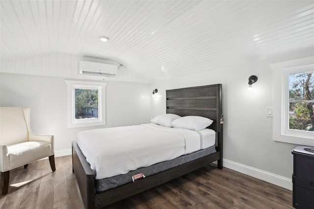 2015 3rd St S, Saint Petersburg, FL 33705 - bedroom featuring an AC wall unit, lofted ceiling, baseboards, and wood finished floors