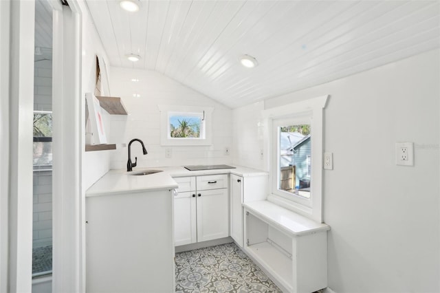 2015 3rd St S, Saint Petersburg, FL 33705 - kitchen with a sink, recessed lighting, light countertops, white cabinets, and light tile patterned flooring