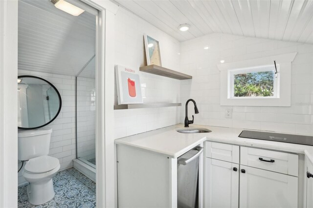 2015 3rd St S, Saint Petersburg, FL 33705 - kitchen with open shelves, a sink, tile walls, white cabinetry, and black electric stovetop
