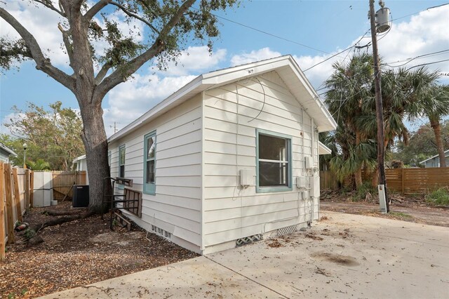 2015 3rd St S, Saint Petersburg, FL 33705 - view of property exterior featuring fence, a patio area, cooling unit, and crawl space