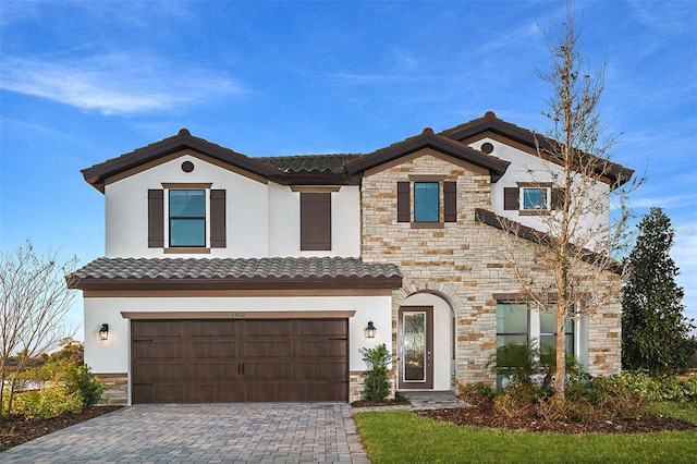 13722 Heartwood Way, Parrish, FL 34219 - view of front of house featuring stone siding, an attached garage, stucco siding, and decorative driveway