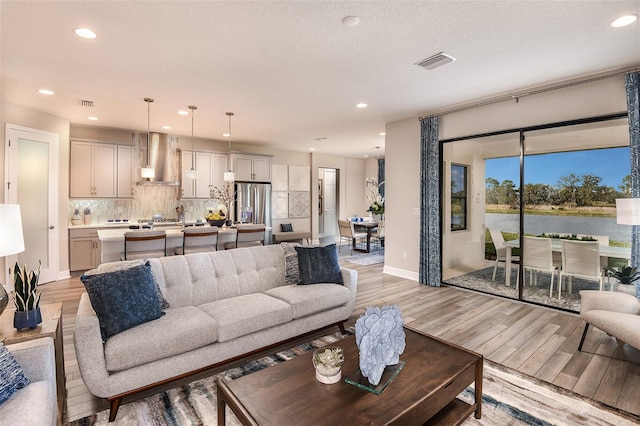 13722 Heartwood Way, Parrish, FL 34219 - living area featuring light wood-style flooring, recessed lighting, and baseboards