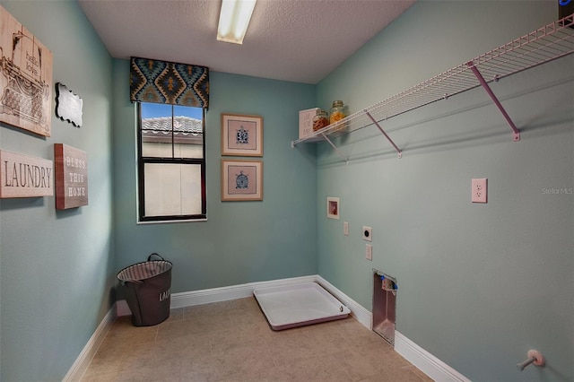 13722 Heartwood Way, Parrish, FL 34219 - laundry room featuring hookup for a washing machine, hookup for an electric dryer, baseboards, and a textured ceiling