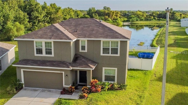 view of front of house featuring stucco siding, a shingled roof, a water view, an attached garage, and concrete driveway