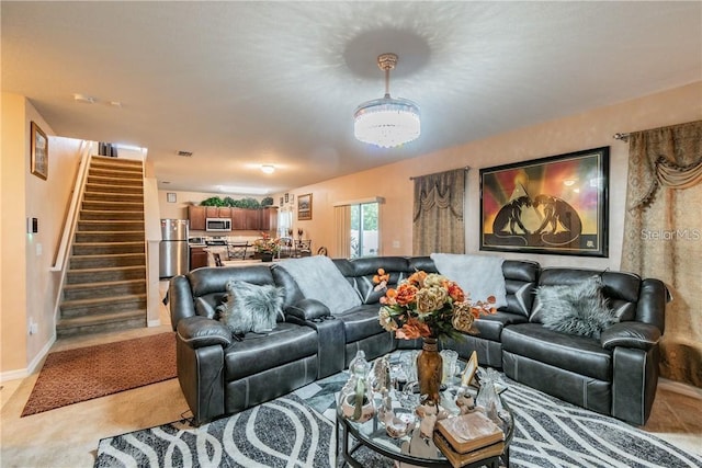 living room featuring stairway and baseboards