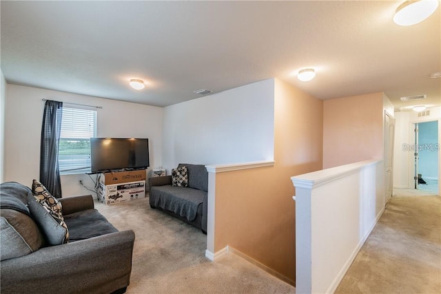 living room featuring light carpet and baseboards