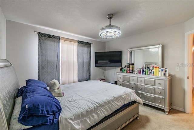 bedroom featuring light colored carpet and baseboards