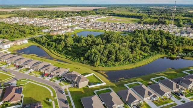 aerial view of property's location featuring nearby suburban area and a large body of water