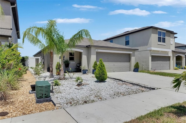 view of front of property featuring stucco siding, concrete driveway, and an attached garage