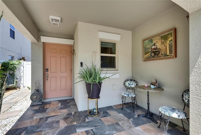property entrance with stucco siding