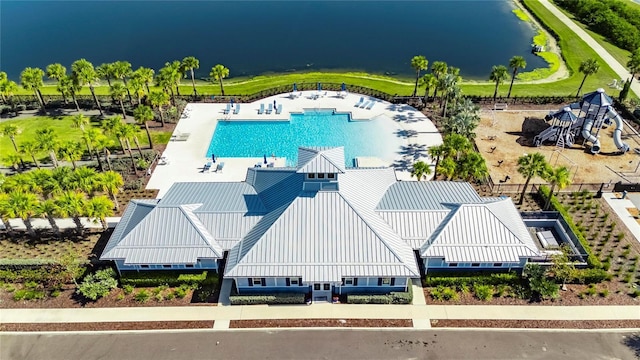 aerial view of a pool area and a nearby body of water