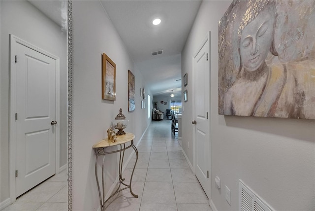 hallway with light tile patterned floors, baseboards, and recessed lighting