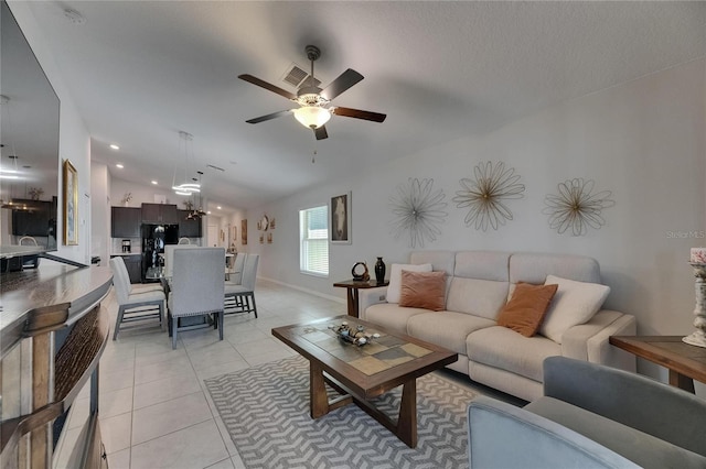 living room featuring ceiling fan, light tile patterned floors, baseboards, recessed lighting, and vaulted ceiling