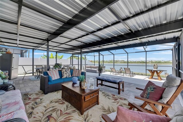 view of patio / terrace with a water view, outdoor lounge area, and glass enclosure